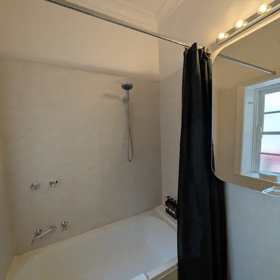 Bathroom with shower over bath at Laneway Studio, Surry Hills